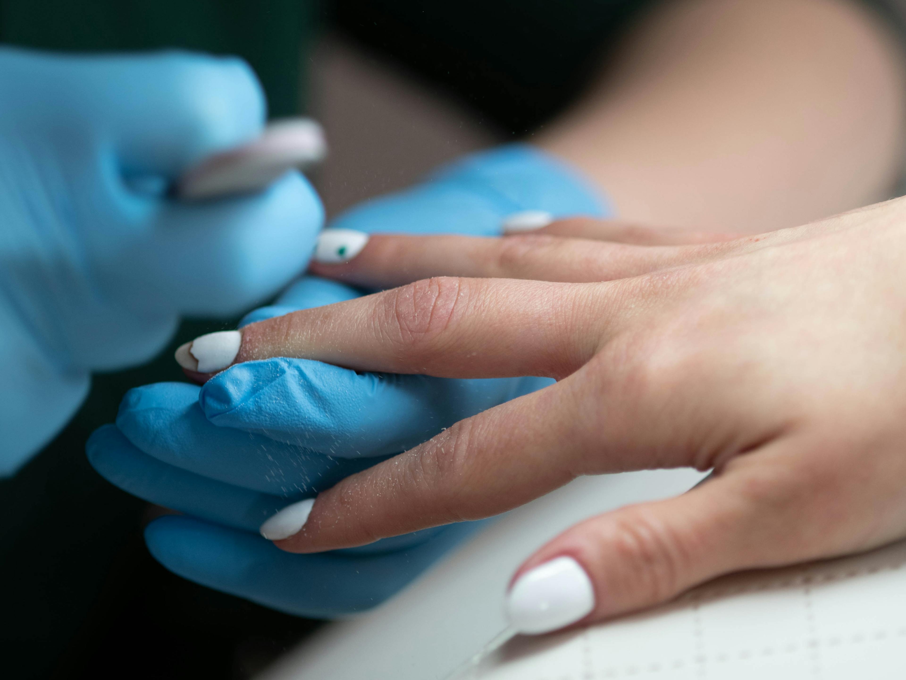 stylistka paznokci wykonuje manicure hybrydowy w salonie kosmetycznym health and beauty w Krakowie